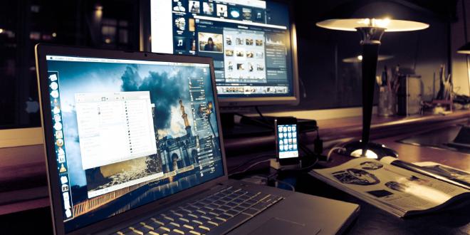 Notebook cerrada sobre una mesa, con documentos de trabajo y un ícono visual de nube en segundo plano